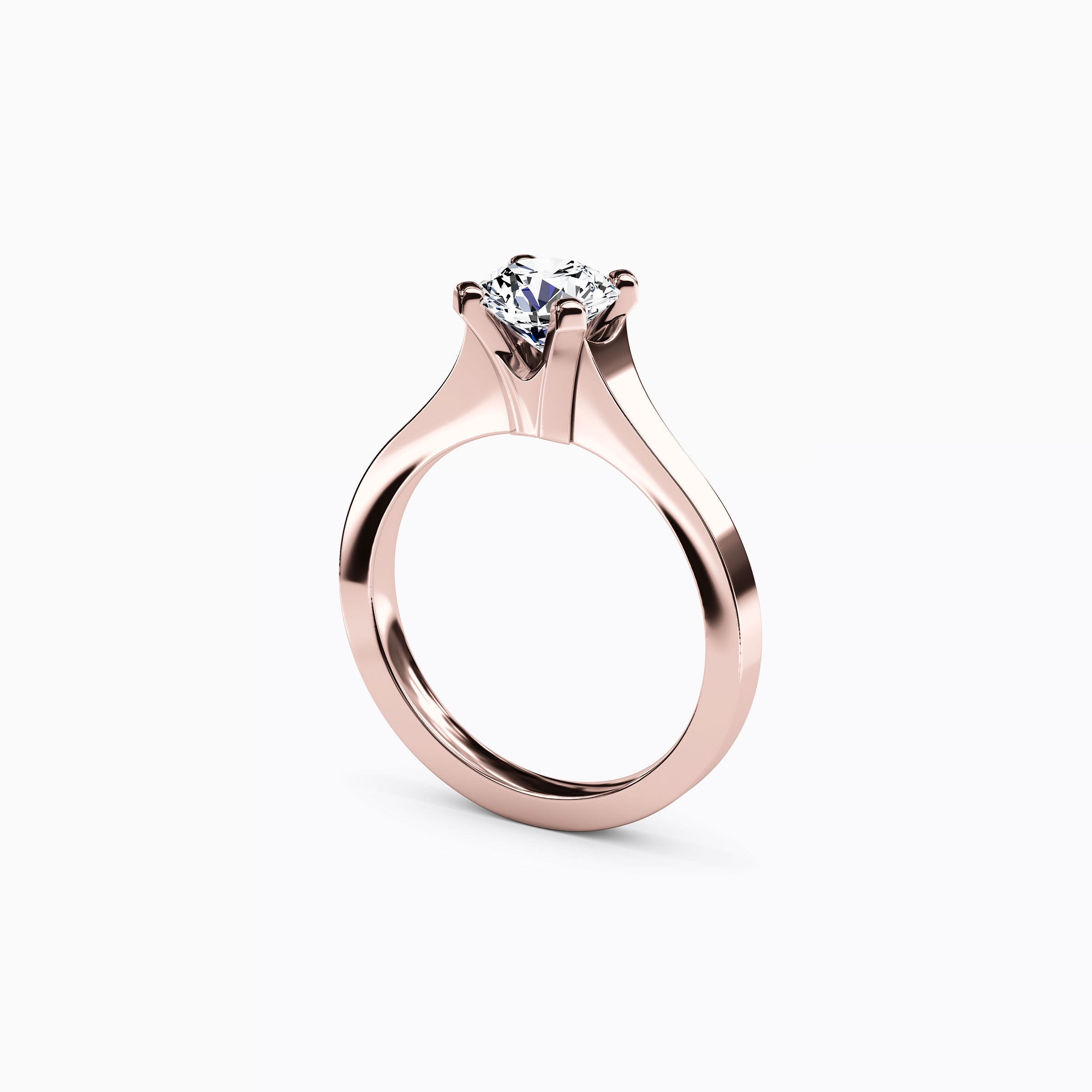 Bague de fiançailles solitaire en or 18 carats, sertie d'un diamant conique.